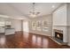 Open-concept living space with fireplace and hardwood floors connected to the kitchen at 441 Concord Cir, Mcdonough, GA 30253