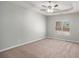 Carpeted main bedroom with a tray ceiling and a ceiling fan with great natural light at 441 Concord Cir, Mcdonough, GA 30253