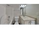 Cozy bathroom features a shower-tub combo, vanity, and good lighting at 45 Kirkland Ct, Covington, GA 30016