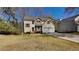 Charming two-story home featuring a well-manicured front yard and attached garage at 45 Kirkland Ct, Covington, GA 30016