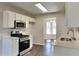 Modern kitchen with stainless steel appliances, white cabinets, and a view to the breakfast nook at 45 Kirkland Ct, Covington, GA 30016