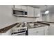 Well-equipped kitchenette featuring sleek countertops, stainless steel appliances, and modern fixtures at 45 Kirkland Ct, Covington, GA 30016