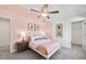 Charming bedroom with pink walls, stylish decor, and natural light from the windows at 3136 Morris Hills Dr, Dacula, GA 30019