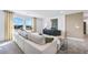 Cozy living room with a large white sectional sofa, stylish decor, and large windows with a view at 3136 Morris Hills Dr, Dacula, GA 30019