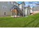Home's lush backyard featuring a deck with stairs leading down to a paved patio and green lawn at 511 Millwood Ct, Canton, GA 30114