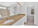 Bright bathroom featuring double sinks, granite countertop, white cabinets and tile floor at 511 Millwood Ct, Canton, GA 30114