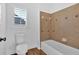 Clean bathroom featuring a toilet and shower-tub combination with tile surround at 511 Millwood Ct, Canton, GA 30114