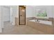 Stylish bathroom featuring a soaking tub, separate shower and neutral tile at 511 Millwood Ct, Canton, GA 30114