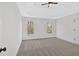 Well-lit bedroom with tray ceiling, neutral carpet and two windows at 511 Millwood Ct, Canton, GA 30114