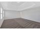 Bright bedroom with neutral carpet, tray ceiling, and ample natural light at 511 Millwood Ct, Canton, GA 30114