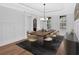 Formal dining area features wainscoting, tray ceiling, chandelier, and seating for six at 511 Millwood Ct, Canton, GA 30114