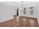 Spacious dining room with hardwood floors, chandelier lighting, and arched doorway at 511 Millwood Ct, Canton, GA 30114