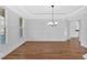 Spacious dining area with hardwood floors, wainscoting, tray ceiling, and plantation shutters at 511 Millwood Ct, Canton, GA 30114