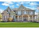 Inviting exterior showcasing a well-manicured lawn, covered porch, and architectural details at 511 Millwood Ct, Canton, GA 30114