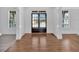Foyer featuring hardwood floors and white pillars leading into other rooms at 511 Millwood Ct, Canton, GA 30114