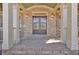 Elegant brick facade and double front door with sidelights, flanked by stately columns and lighting at 511 Millwood Ct, Canton, GA 30114