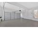 Spacious two car garage featuring white walls, a neutral floor and an automatic door opener at 511 Millwood Ct, Canton, GA 30114