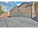 Three-car garage with green doors and large driveway, offering ample parking and storage space at 511 Millwood Ct, Canton, GA 30114