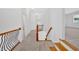 A well-lit second-floor hallway features wooden railings, carpet, and neutral wall colors at 511 Millwood Ct, Canton, GA 30114