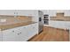 Beautiful kitchen featuring stainless steel appliances, granite counters and hardwood floors at 511 Millwood Ct, Canton, GA 30114