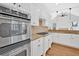 Modern kitchen with stainless steel appliances, granite counters, and decorative backsplash at 511 Millwood Ct, Canton, GA 30114