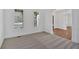 Bright living room with white trim, carpet floors and shuttered windows at 511 Millwood Ct, Canton, GA 30114
