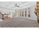 Sunlit living room features a stone fireplace, coffered ceiling, and large windows at 511 Millwood Ct, Canton, GA 30114