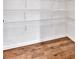Walk-in pantry with bright white walls, wire shelving, and hardwood floors at 511 Millwood Ct, Canton, GA 30114