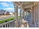View of front porch with white columns, brick floor, and neighborhood view at 511 Millwood Ct, Canton, GA 30114