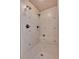 Nicely tiled shower with multiple shower heads and a built-in bench at 511 Millwood Ct, Canton, GA 30114