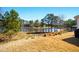 Backyard featuring a pond, trees and lawn at 555 Birkdale Dr, Fairburn, GA 30213