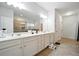 Bathroom featuring double sinks and spacious countertops with a tiled floor at 555 Birkdale Dr, Fairburn, GA 30213