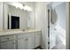 This bathroom features a large mirror and a white vanity with storage at 555 Birkdale Dr, Fairburn, GA 30213