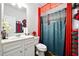 Bright bathroom features a white vanity and a blue shower curtain with red trim at 555 Birkdale Dr, Fairburn, GA 30213