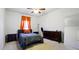 Bedroom with neutral carpet, a ceiling fan, and orange curtains at 555 Birkdale Dr, Fairburn, GA 30213