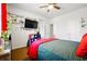 This bedroom features light-colored walls, wood floors, and a large TV at 555 Birkdale Dr, Fairburn, GA 30213