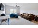 Spacious bonus room with plush carpet, a large sofa, and a ceiling fan at 555 Birkdale Dr, Fairburn, GA 30213