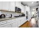 Well-equipped kitchen featuring white cabinets, stainless steel appliances, granite counters, and subway tile backsplash at 555 Birkdale Dr, Fairburn, GA 30213