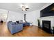 Spacious living room with fireplace, and hardwood floors, complete with modern decor, and large windows at 555 Birkdale Dr, Fairburn, GA 30213