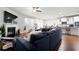 Bright living room featuring a fireplace, ceiling fan, hardwood floors, and open access to the kitchen at 555 Birkdale Dr, Fairburn, GA 30213