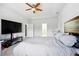 Spacious bedroom with neutral carpet, tray ceilings, and ceiling fan at 555 Birkdale Dr, Fairburn, GA 30213
