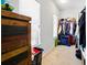 Walk-in closet with window, wood storage cabinet, and metal clothing racks at 555 Birkdale Dr, Fairburn, GA 30213