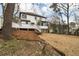 Backyard of a two-story home with a spacious lawn, a deck, and some mature trees at 1936 Oak Ridge Ct, Marietta, GA 30062