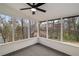 Screened-in porch featuring a ceiling fan and wooded backyard views at 1936 Oak Ridge Ct, Marietta, GA 30062