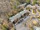 An aerial view captures the townhome, with landscaping, trees, and ample parking spaces at 213 Tuxworth Cir, Decatur, GA 30033