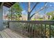 Spacious wooden balcony with a gray railing overlooking lush landscaping and trees at 213 Tuxworth Cir, Decatur, GA 30033