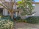 Exterior view of the building featuring a balcony, green landscaping, and trees at 213 Tuxworth Cir, Decatur, GA 30033
