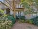 Building exterior featuring a balcony, green landscaping, and lush trees at 213 Tuxworth Cir, Decatur, GA 30033