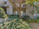Exterior view of condo building surrounded by green landscaping and mature trees at 213 Tuxworth Cir, Decatur, GA 30033