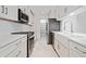 Bright kitchen features white cabinets, stainless appliances, and a white farmhouse sink at 213 Tuxworth Cir, Decatur, GA 30033